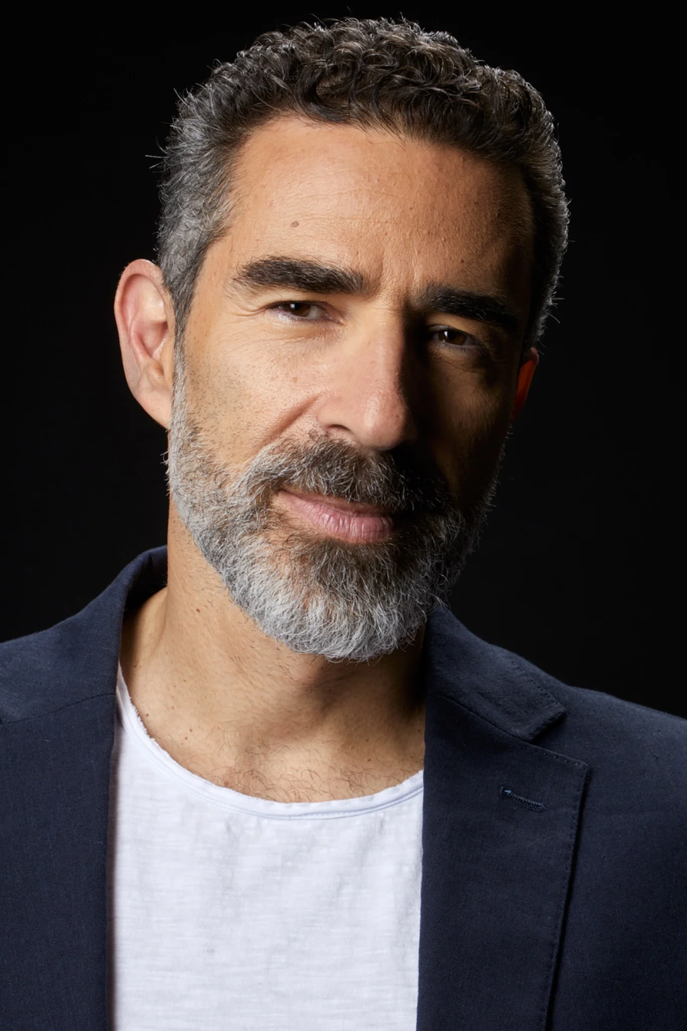Georgios Mantzakos wearing a navy blazer, close-up portrait